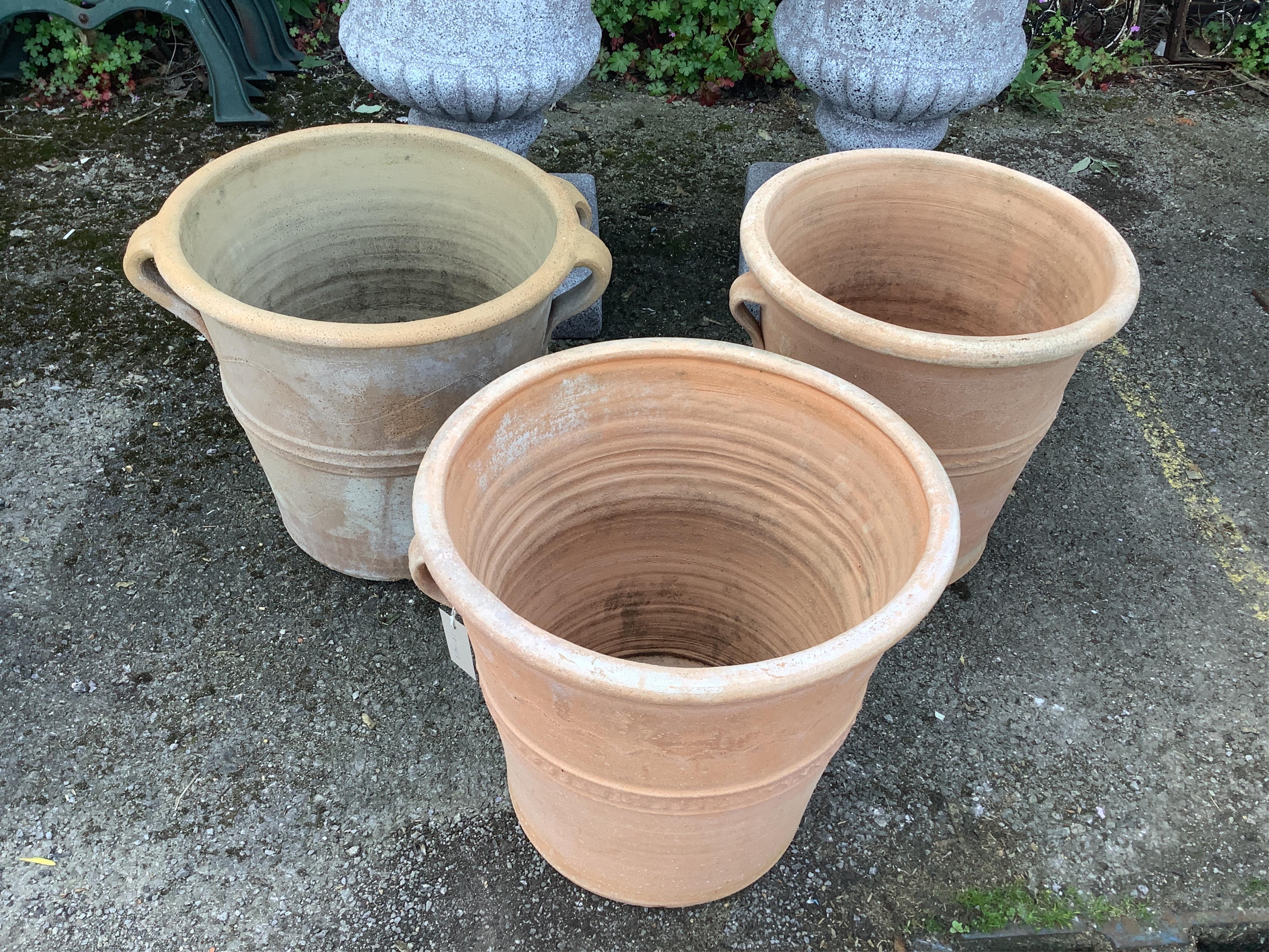 Three circular terracotta garden planters, diameter 41cm, height 38cm
